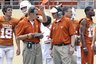Texas' co-offensive coordinators Major Applewhite, front right, and Bryan Harsin, front left, talk during the Texas Orange and White spring football scrimmage on Sunday, April 3, 2011, in Austin, Texas. The Orange team won 27-7. (AP Photo/Michael Thomas)