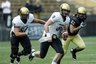 Colorado gold team quarterback Tyler Hansen, front, runs for yardage as gold team offensive lineman David Bakhtiari, back left, and black team defensive end Josh Hartigan trail the play during the spring scrimmage game in Folsom Field in Boulder, Colo., on Saturday, April 10, 2010. (AP Photo/David Zalubowski)