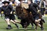 Handlers called "Ralphie runners" guide Ralphie V, mascot of the University of Colorado, around the surface of Folsom Field before the spring scrimmage game in Folsom Field in Boulder, Colo., on Saturday, April 10, 2010. (AP Photo/David Zalubowski)