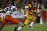 LOS ANGELES - SEPTEMBER 11:  Running back Dillon Baxter #28 of the USC Trojans carries the ball against linebacker Ausar Walcott #26 of the Virginia Cavaliers at Los Angeles Memorial Coliseum on September 11 2010 in Los Angeles California. (Photo by Stephen Dunn/Getty Images)